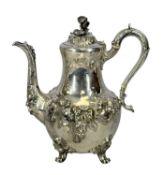 VICTORIAN SILVER COFFEE POT, repoussé decoration of flowers and leaves, leaf-capped scroll handle,