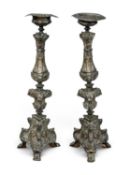 PAIR OF ORNATE EMBOSSED BRASS FLOOR-STANDING CANDLE STANDS, 110cms (h) Provenance: private