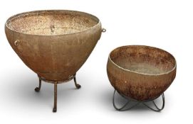 TWO TRADITIONAL INDIAN METAL KADAI POTS ON STANDS, 70 (h) x 50cms (diam.) the largest Provenance: