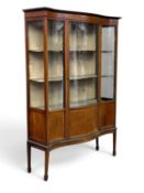 EDWARDIAN MAHOGANY SINGLE-DOOR DISPLAY CABINET, glass and serpentine fronted, on spade feet, 174 (h)