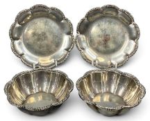 PAIR OF WHITE METAL CIRCULAR SCALLOPED BOWLS with moulded borders and matching dishes, possibly