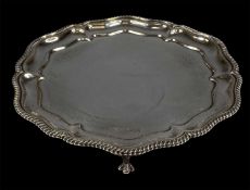 GEORGE V CIRCULAR SILVER WAITER, gadrooned and moulded rim, on three claw feet, Walker & Hall,