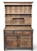 20TH CENTURY OAK DRESSER of narrow proportions, the rack with multiple shelves, two cupboard