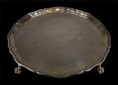 GEORGE VI CIRCULAR SILVER WAITER with bead and moulded rim, on four claw and ball feet, Ollivant &