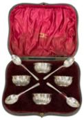 CASED SET OF FOUR CIRCULAR OPEN SALTS with gadrooned decoration and gilt interiors, with four silver