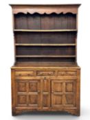 ANTIQUE OAK WELSH DRESSER, three-shelf rack with shaped hood, base with raised and fielded panels,