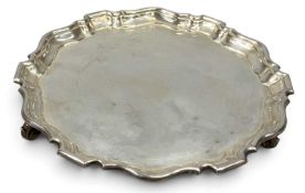 ELIZABETH II CIRCULAR SILVER WAITER with shaped moulded rim, on three scroll feet, William