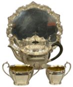 THREE-PIECE EPNS TEA SERVICE of panelled oval form, with an EPNS circular waiter Provenance: private