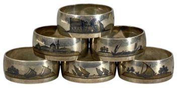 SET OF SIX EASTERN WHITE METAL NIELLO NAPKIN RINGS decorated with Nile scenes, 153.5g Provenance: