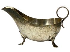 GEORGE VI SILVER SAUCEBOAT of plain design, with ring handle and on three pad feet, James Dixon &