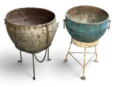 TWO TRADITIONAL INDIAN METAL KADAI POTS ON STANDS, 57 (h) x 56cms (diam.) the largest Provenance: