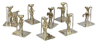 SET OF EIGHT WHITE METAL MENU HOLDERS modelled as musicians, possibly Mexican, each marked '900',
