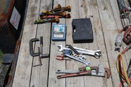 Tools including two pipe wrenches, wrenches, vise, and ratchet