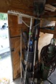 Hand tools including shovels, sledgehammers, post hole diggers, rake, and tripod