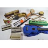 A collection of musical related instruments, including 1970s Stylophones, a Mahalo ukulele, mouth