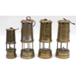 A group of four brass and steel miners lamps, including two British Coal Mining Company Wales U.k, a