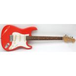 A 1980s Cruiser electric guitar by Crafter, in the style of a Fender Stratocaster, fiesta red finish