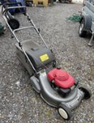 A Honda HRD535 petrol rotary lawnmower with collection tray.
