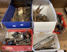 A collection of wood plane irons, soles, blade clamps and wedges by makers Sorby, Ward and