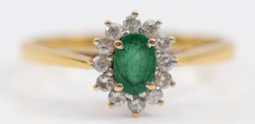An 18ct gold emerald and brilliant cut diamond cluster ring, Birmingham 1987, S, 2.7g