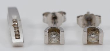 A pair of 9ct white gold brilliant cut diamond earrings with scroll backs, approximately 0.10ct