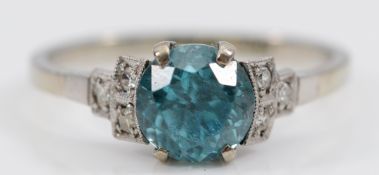 An Art Deco 18ct white gold blue zircon single stone ring, white stone stepped shoulders, K, 2.2g