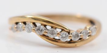 A 9ct gold brilliant cut diamond cross over ring, one diamond loose in it's setting, N, 1.7g