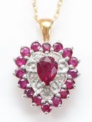 A 9ct gold ruby and single cut diamond pendant on a chain, 2.7g
