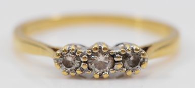 An 18ct gold brilliant cut diamond three stone ring, O, 2.3g