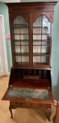 An Edwardian inlaid mahogany and walnut veneer bureau bookcase, with astragal glazed doors enclosing