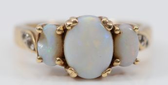 A 9ct gold opal three stone ring with diamond set shoulders, Birmingham 2007, one opal is chipped,