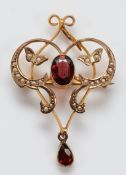 A Victorian 9ct gold garnet and seed pearl brooch, with pendant loop, 9ct tab to the rear, 40mm, 3.
