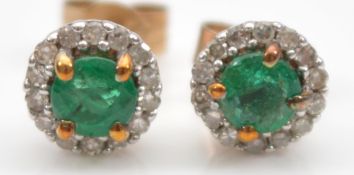 A pair of 9ct gold emerald and brilliant cut diamond earrings with scroll backs, 0.8g