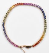 A 9ct gold vari hue sapphire bracelet, 19cm, 9.4g