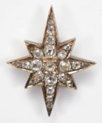 A Victorian unmarked 9ct gold and silver set old mine cut diamond star, possibly from the front of a