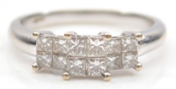 An 18ct white gold Princess cut diamond dress ring, claw set with four stones of approximately 0.