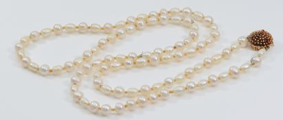 A 585 gold and ruby clasped cultured pearl necklace, 96cm, clasp weighs approximately 7g