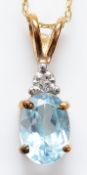 A 9ct gold single cut diamond and blue topaz pendant on a chain, 1.1g