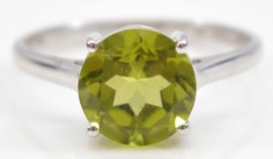 A TGGC 9ct white gold peridot solitaire ring, Birmingham 2014, Q, 2.6g