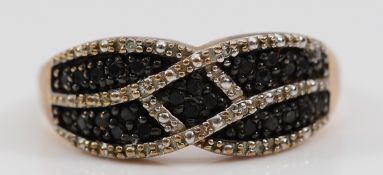 A 9ct gold single cut diamond dress ring, with black diamonds to the centre of the pattern, stated