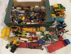 A collection of loose play worn diecast model vehicles, including a collection of farming equipment,