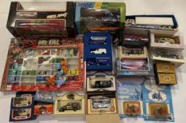 A collection of boxed diecast model vehicles, including Maisto, ERTL and Matchbox, in one box.