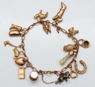 A 9ct gold charm bracelet with fifteen gold charms to include a drum with mother of pearl and an
