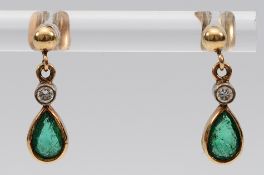 A pair of 9ct gold emerald and brilliant cut diamond earrings with scroll backs, 1.1g