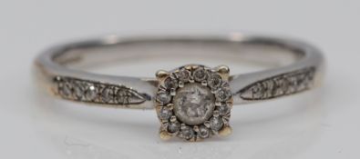 A 9ct white gold brilliant cut diamond single stone ring, stated weight 020cts, bordered by
