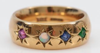 A 9ct gold ruby, opal, sapphire and emerald band ring, Birmingham 1995, 6mm wide, I, 6.7g