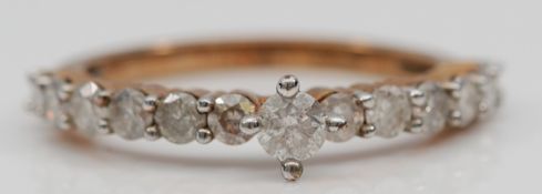 A 9ct gold brilliant cut diamond dress ring, central diamond approximately 0.15ct, O, 2.4g