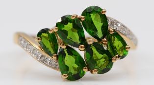 A QVC 9ct gold diopside six stone ring with diamond set shoulders, O, 2.3g