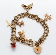 A 9ct gold double curb chain charm bracelet, with a heart shaped padlock clasp, six charms of