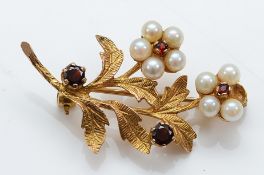 A 9ct gold garnet and cultured pearl floral brooch, London 1964, 37mm, 4.7g